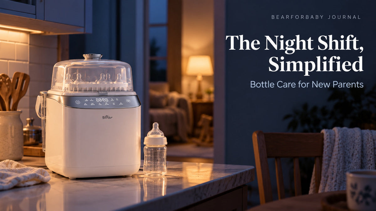 A closed BEAR bottle washer and baby bottle in a softly lit kitchen at dusk, introducing bottle care for new parents.