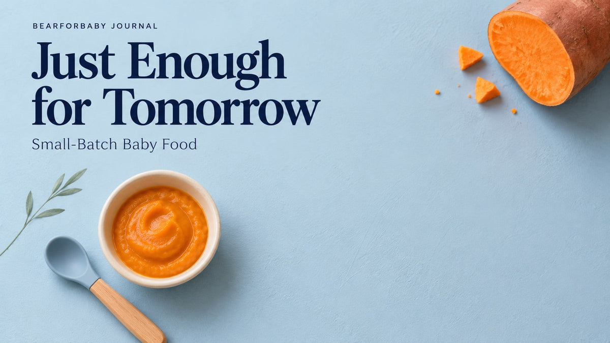 A small bowl of sweet potato puree and baby spoon on a spacious blue tabletop, emphasizing small-batch baby food.