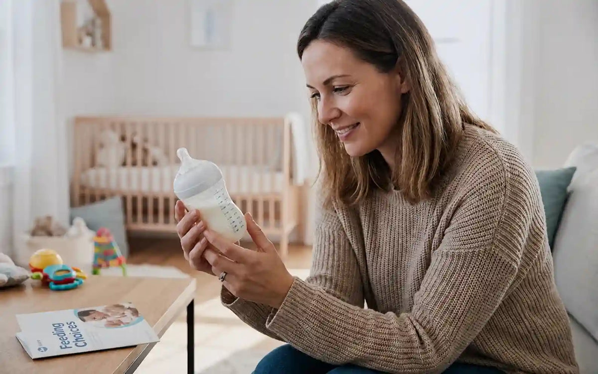 Mother holding a prepared baby milk bottle at home, illustrating the Bearforbaby Baby Bottle Warmer.