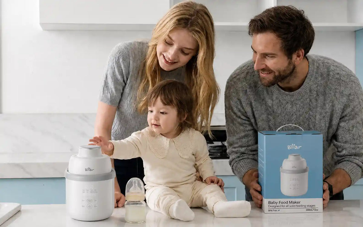 Bearforbaby NutriEase Stainless Steel All Stage Baby Food Maker with a family and baby in the kitchen.
