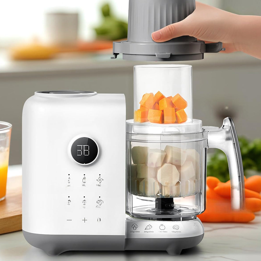Hand adding diced ingredients into the Bear OneStep Baby Food Processor for healthy meal preparation.