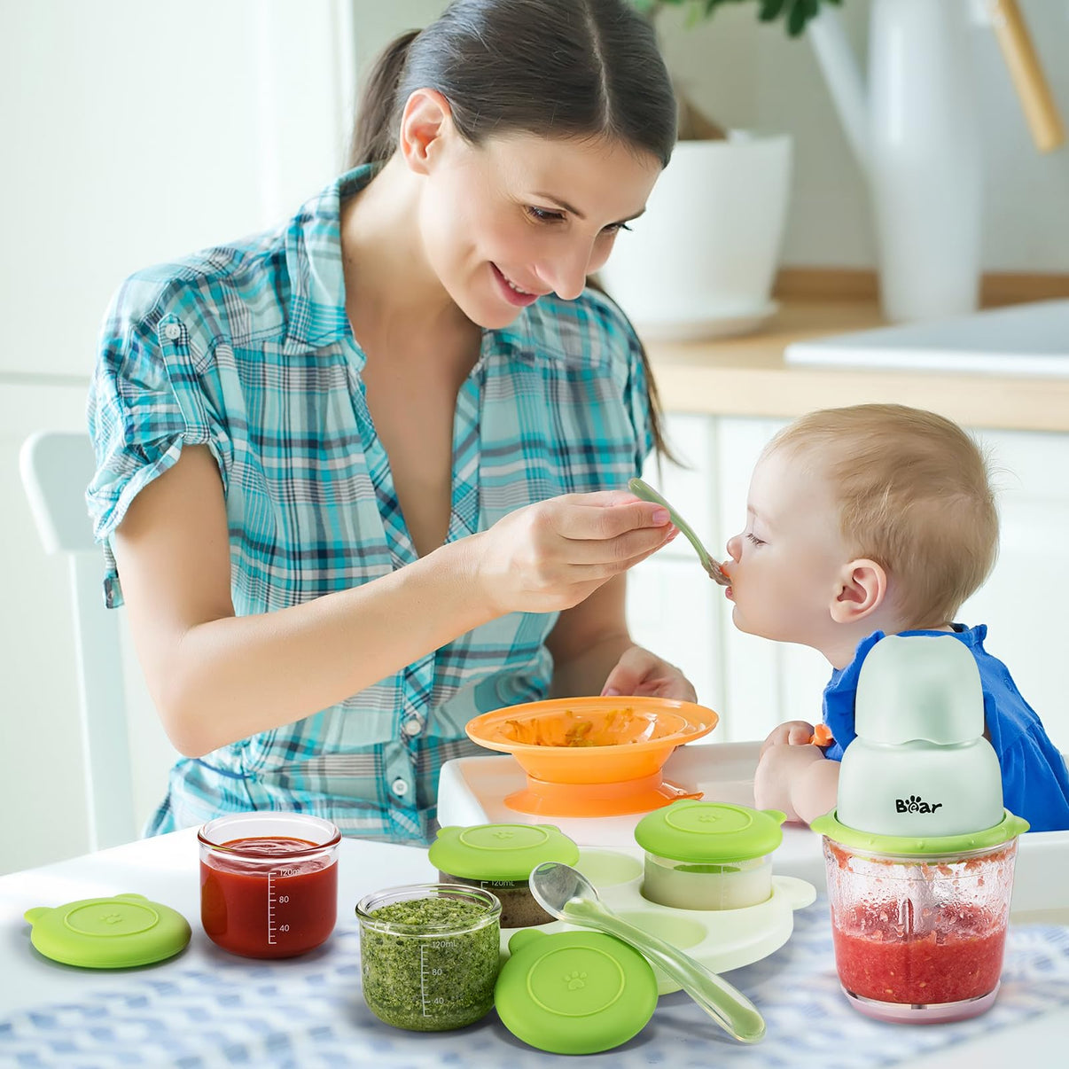 Mother feeding baby fresh organic puree using the Bear Baby Food Processor and storage set in a kitchen.