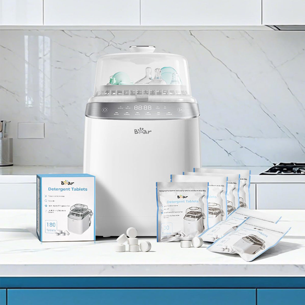 Bear Bottle Washer Pro with 180-count Detergent Tablets box and resealable pouches on a kitchen counter.