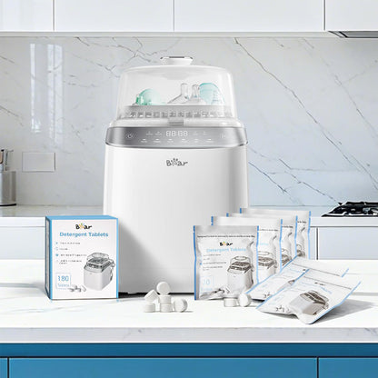 Bear Bottle Washer Pro with 180-count Detergent Tablets box and resealable pouches on a kitchen counter.