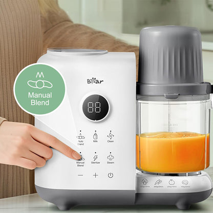 Close-up of finger pressing Manual Blend on the Bear OneStep Baby Food Processor's digital touch panel.
