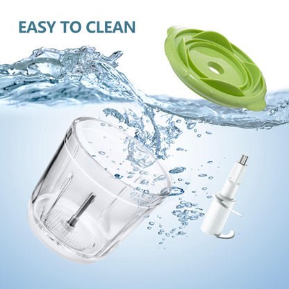 Detachable glass bowl and blades of the Bear Baby Food Processor being rinsed in water for cleaning.