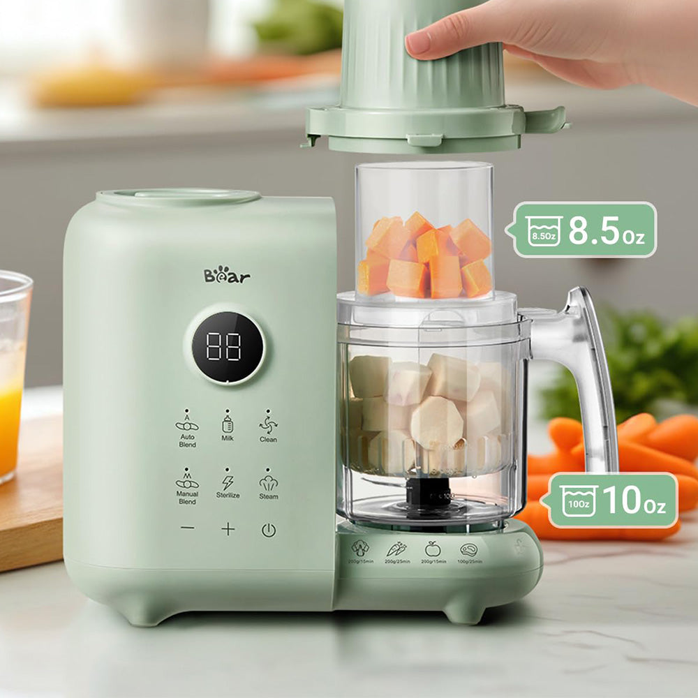 Close-up of the 8.5oz and 10oz dual-layer steam baskets on the mint green Bear 4-in-1 Baby Food Maker.