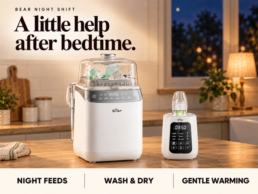 BEAR Bottle Washer Pro and baby bottle warmer on an oak counter in a softly lit kitchen at night.