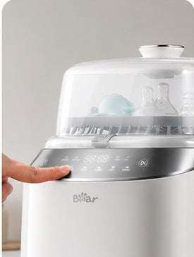 A person presses a button on the control panel to start the machine.